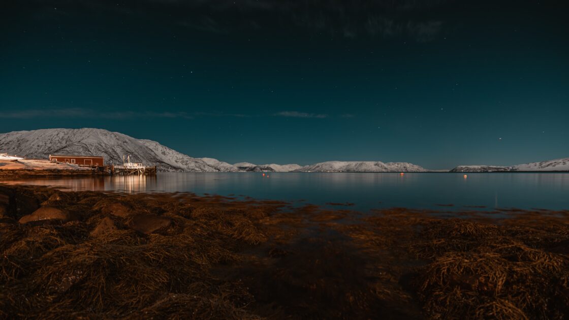 Scenery of Northern lights over the ocean in Alta, Norway